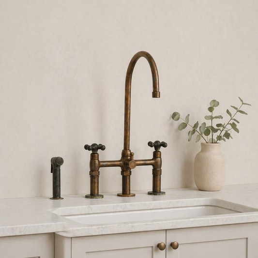 Aged brass bridge kitchen faucet with side sprayer, high-arc spout and cross handles