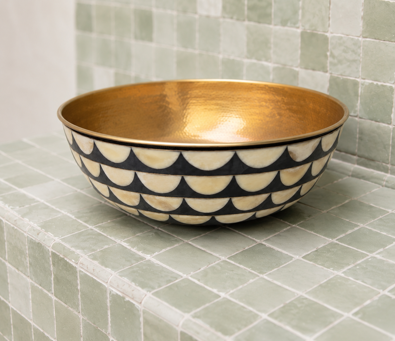 Luxury handmade Moroccan brass vessel sink featuring handcrafted resin and natural bone inlay with a polished brass interior.