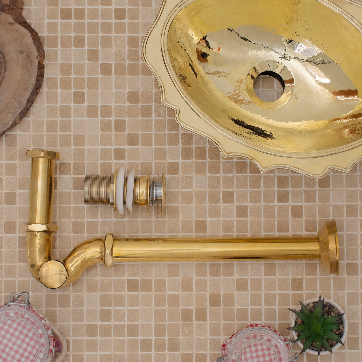 Solid unlacquered brass bathroom sink P-trap and push-button pop-up drain assembly with matching exposed plumbing components.