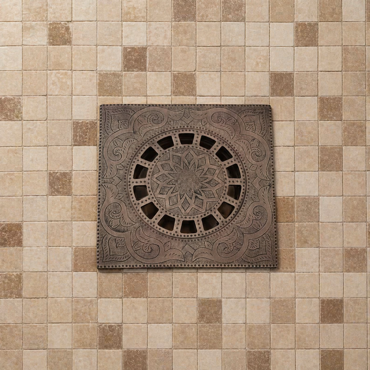 Handmade Moroccan copper shower drain with engraved square floor drain cover installed on beige mosaic bathroom tiles