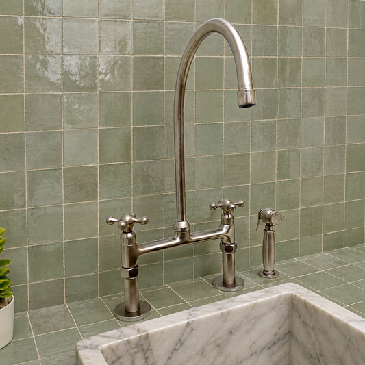 Nickel-finish brass bridge kitchen faucet with cross handles and integrated pull-down sprayer