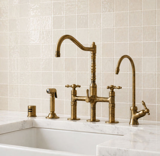 Unlacquered brass bridge kitchen faucet with cross handles and matching handheld side sprayer