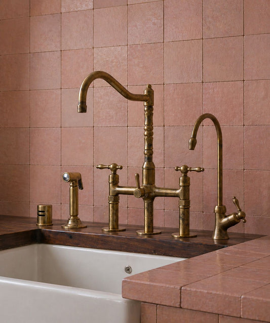 Unlacquered brass bridge kitchen faucet with cross handles and handheld side sprayer